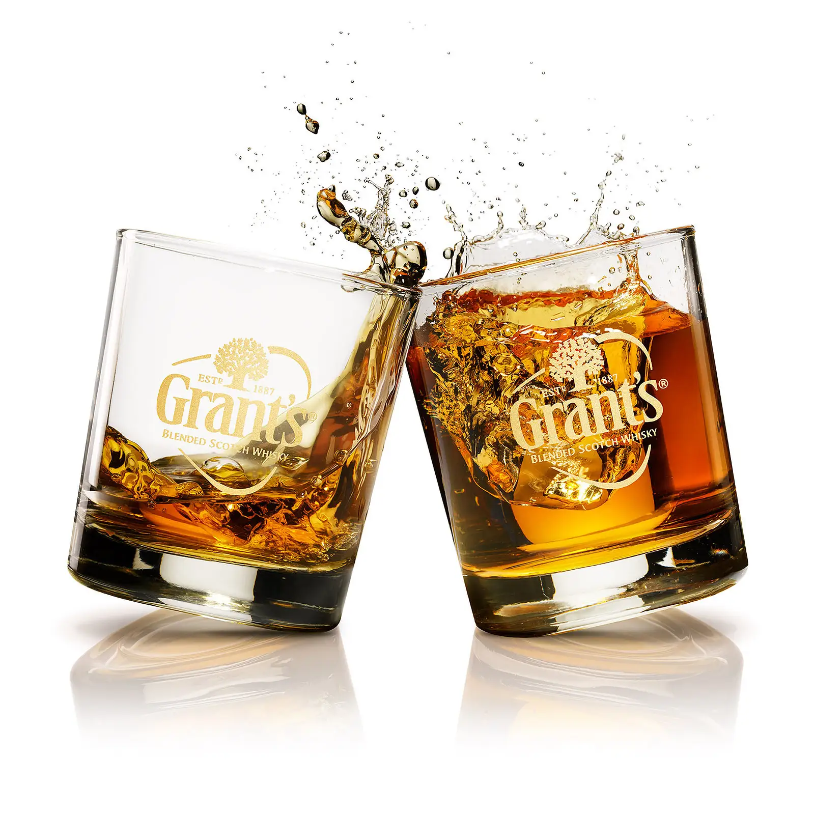 Grant's whiskey tumbling through a splash with ice